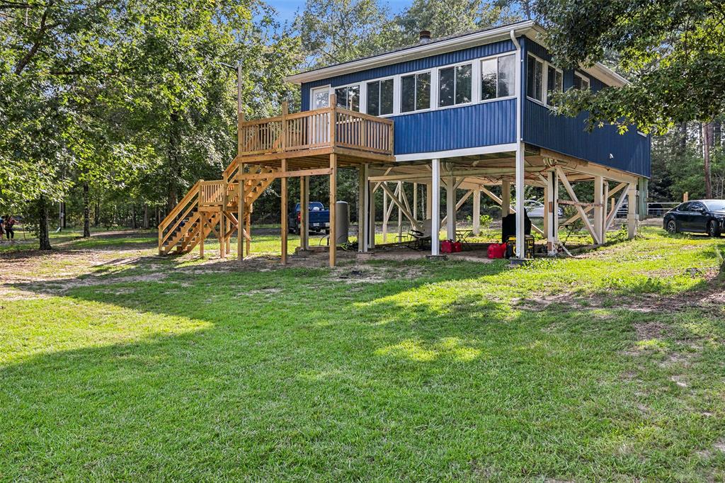 a view of a house with a yard patio and a slide