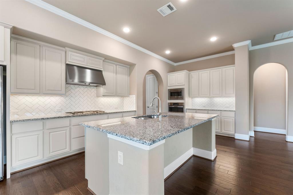 a kitchen with stainless steel appliances granite countertop a sink stove and microwave