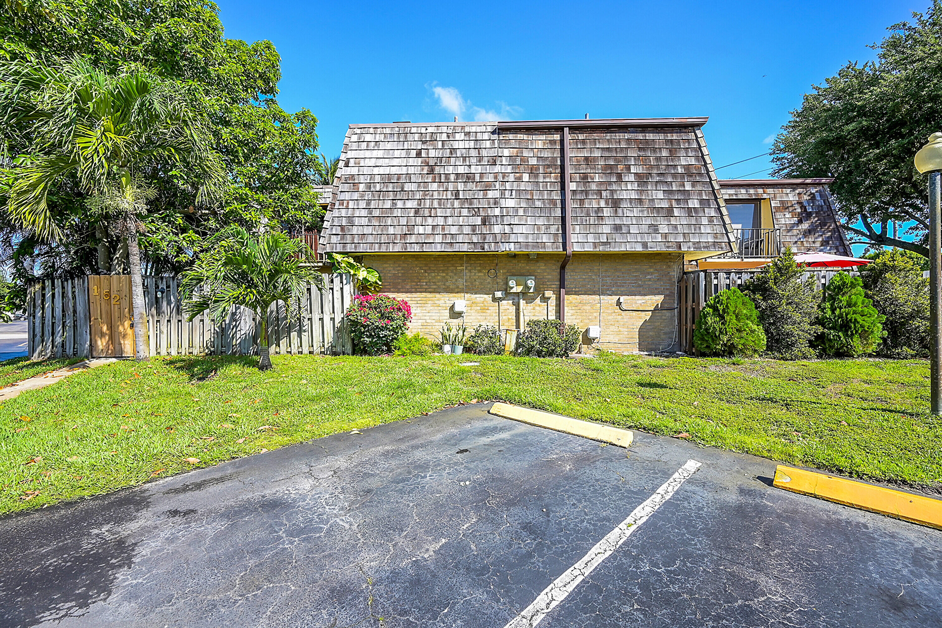 a view of a house with backyard and a sitting area