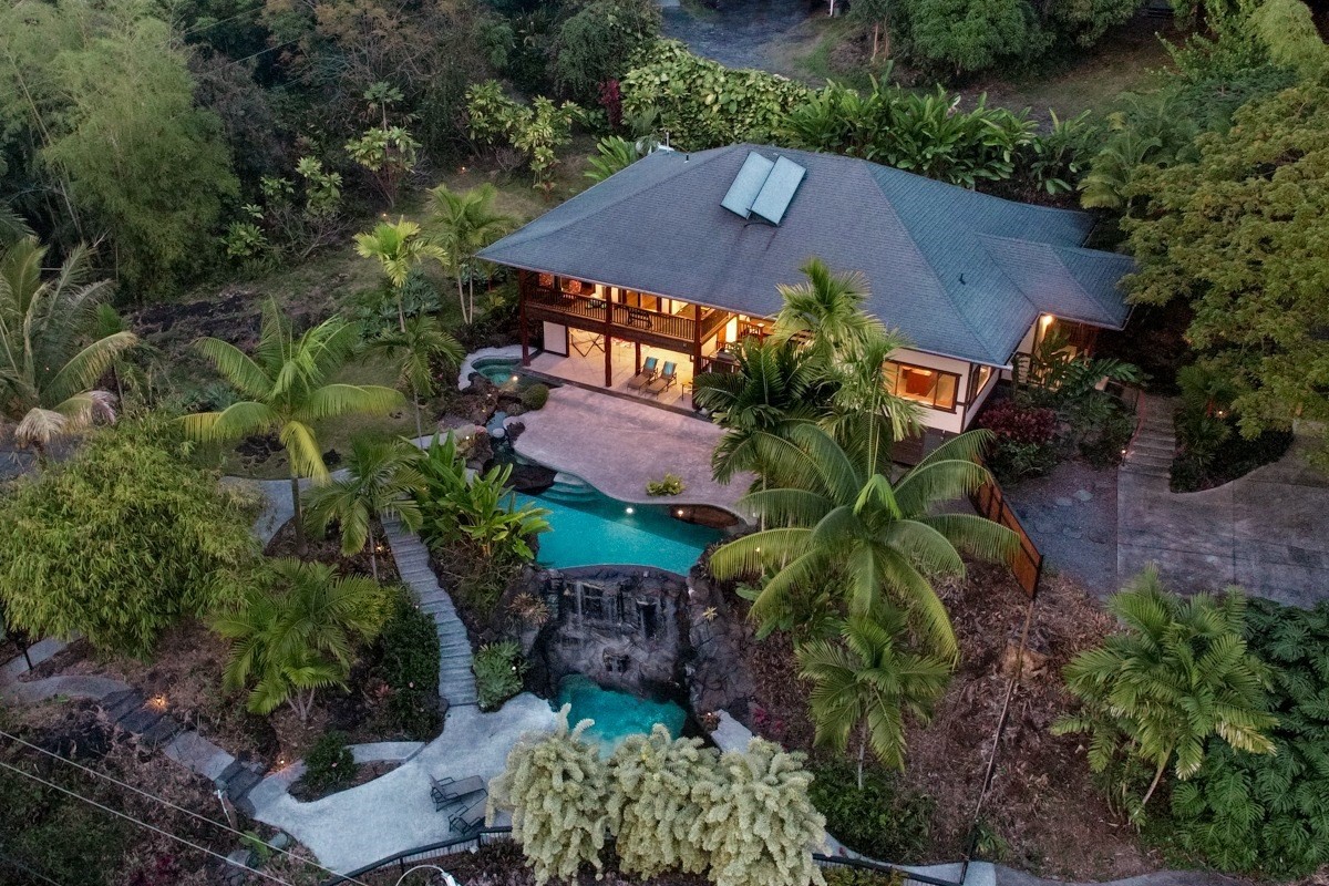 an aerial view of a house with garden space and a street view