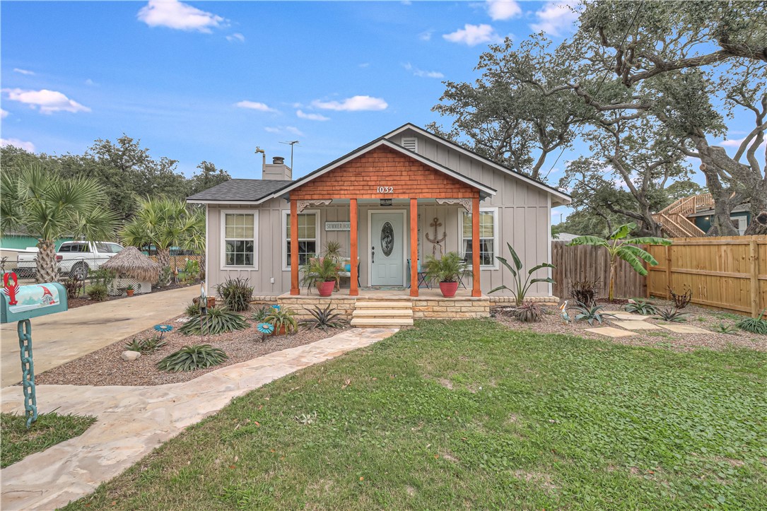 a view of a house with a yard and sitting area