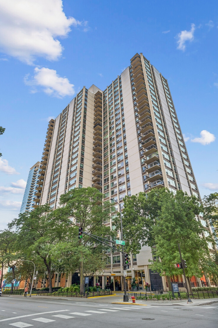 a view of a tall building next to a road