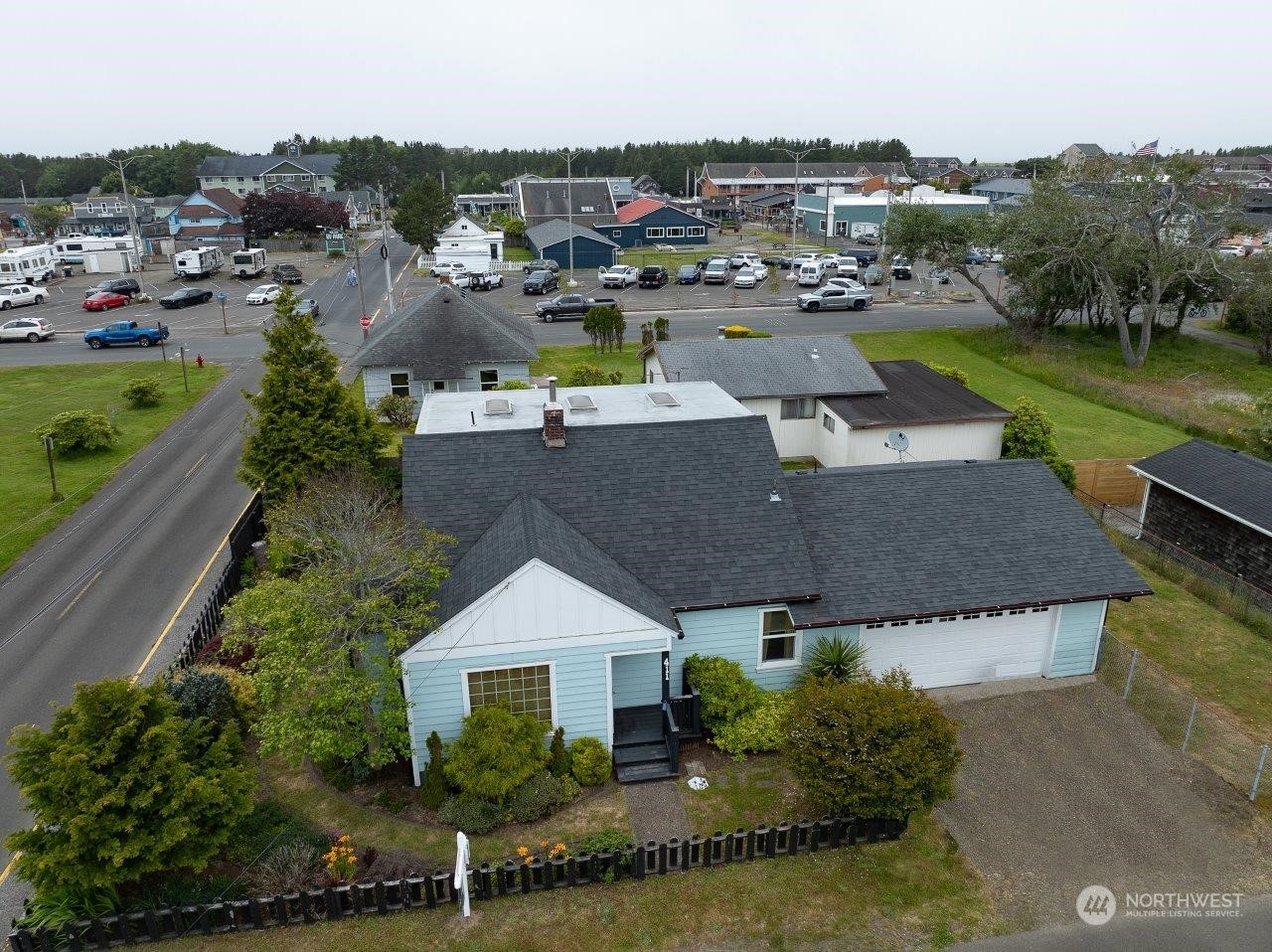 an aerial view of a house with garden space and lake view