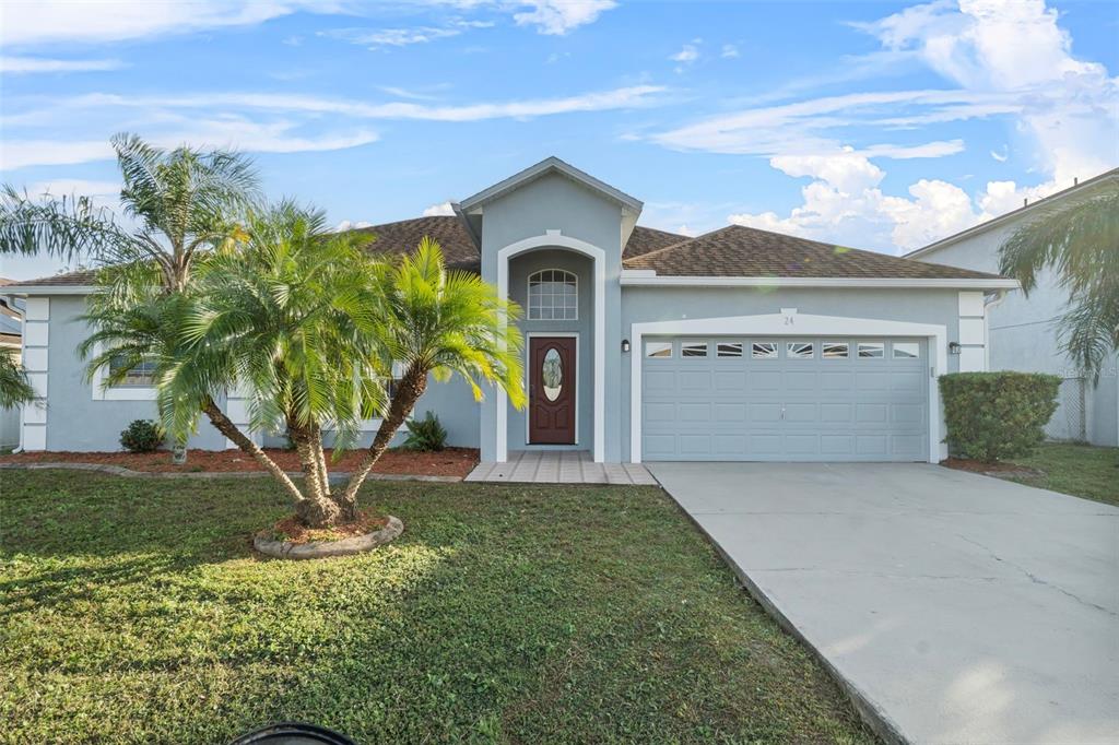 a front view of a house with a yard and garage