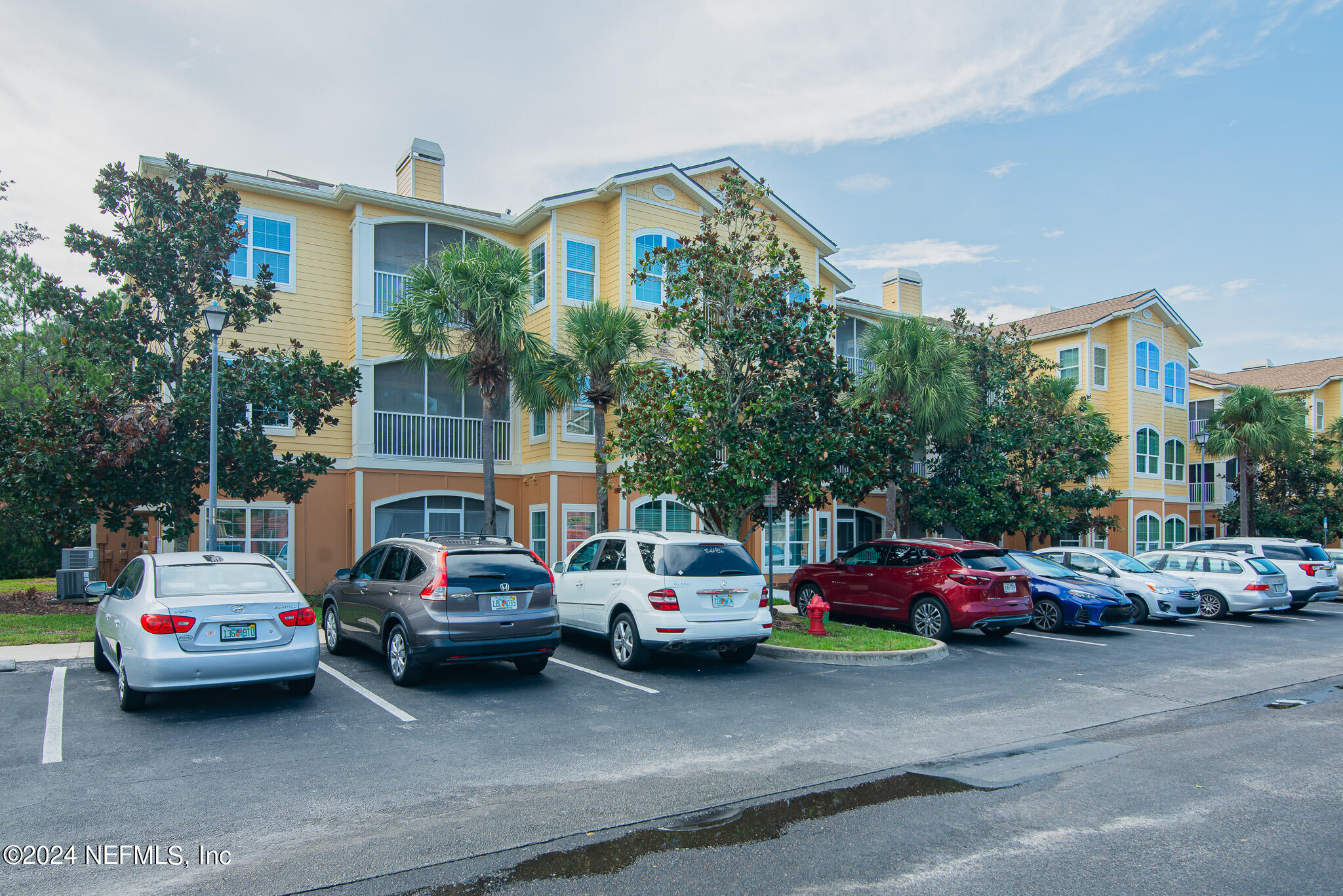 a view of cars parked in front of a house