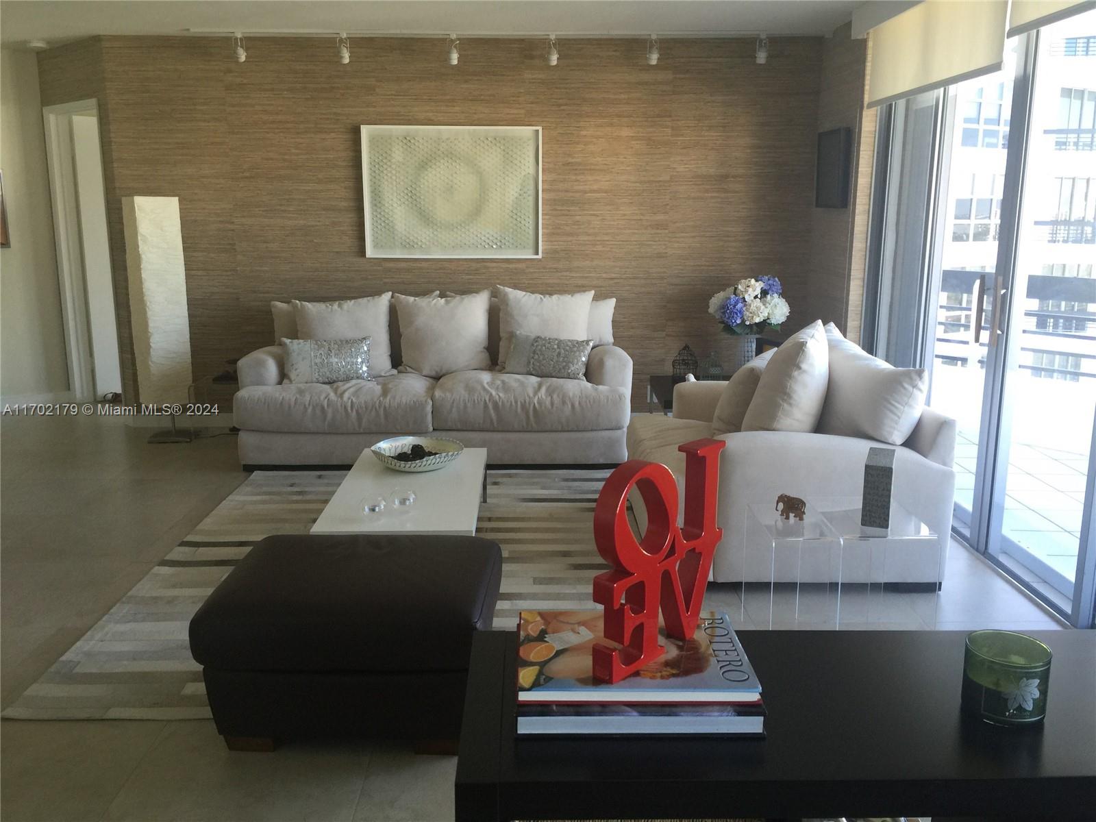 a living room with furniture flowerpot and window