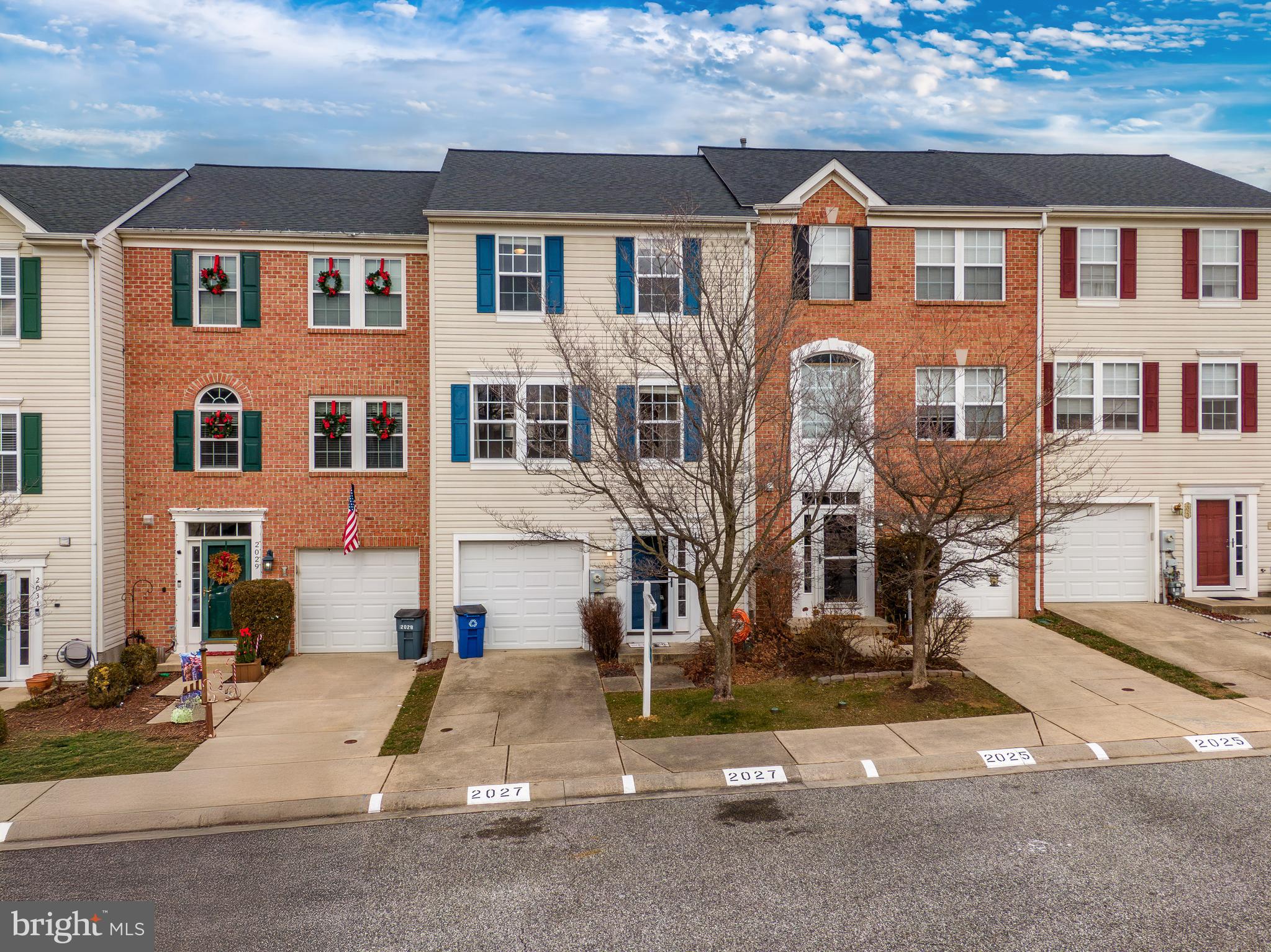 a front view of a residential apartment building with a yard