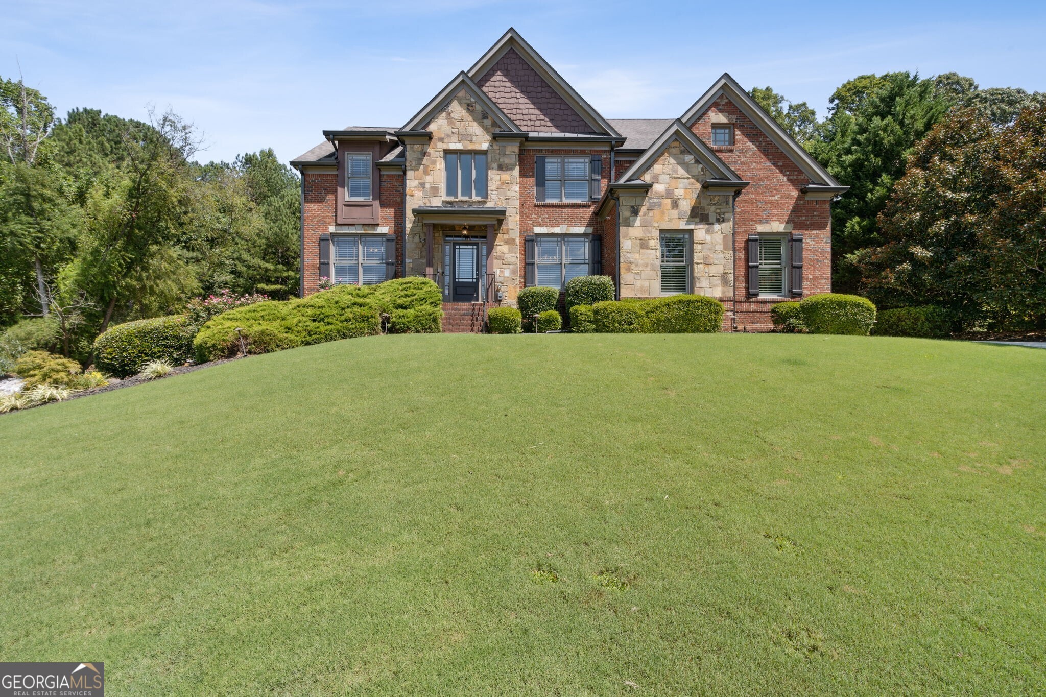 a front view of a house with a yard and garage