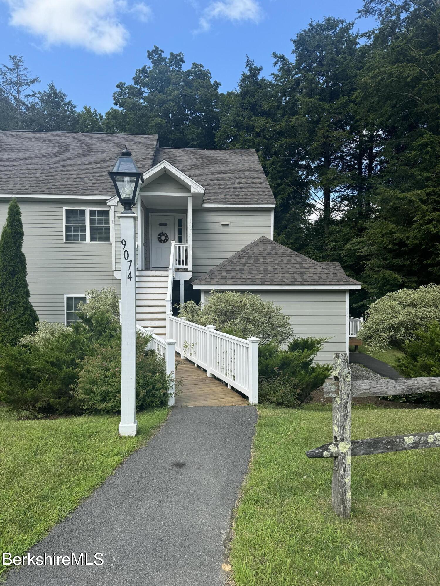 a view of a house with yard and a garden