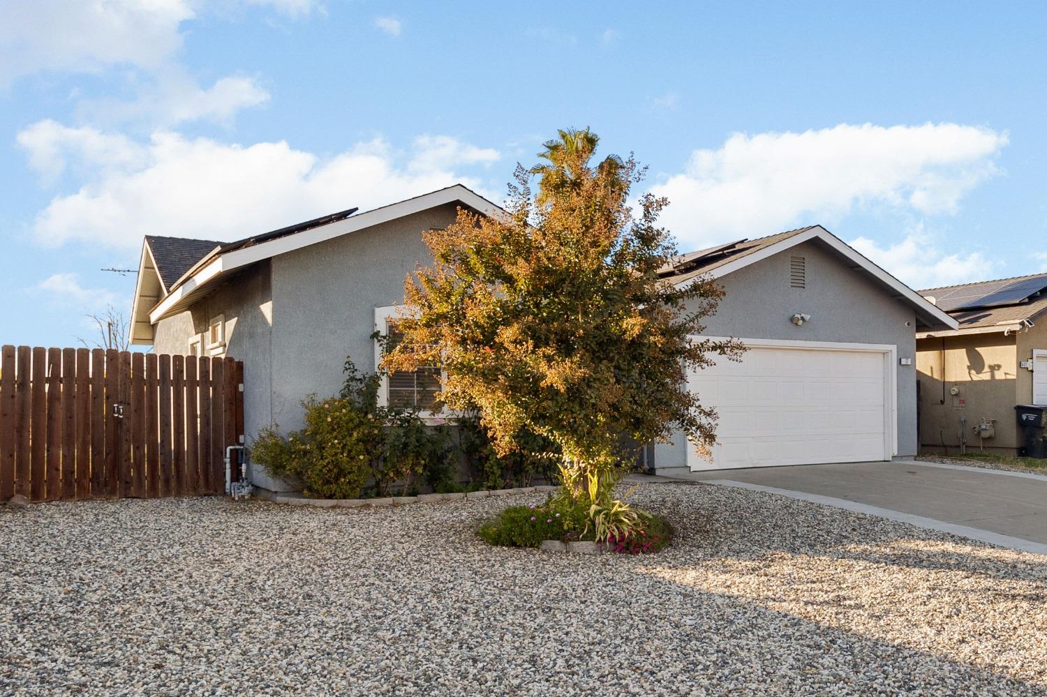 a view of a house with a tree