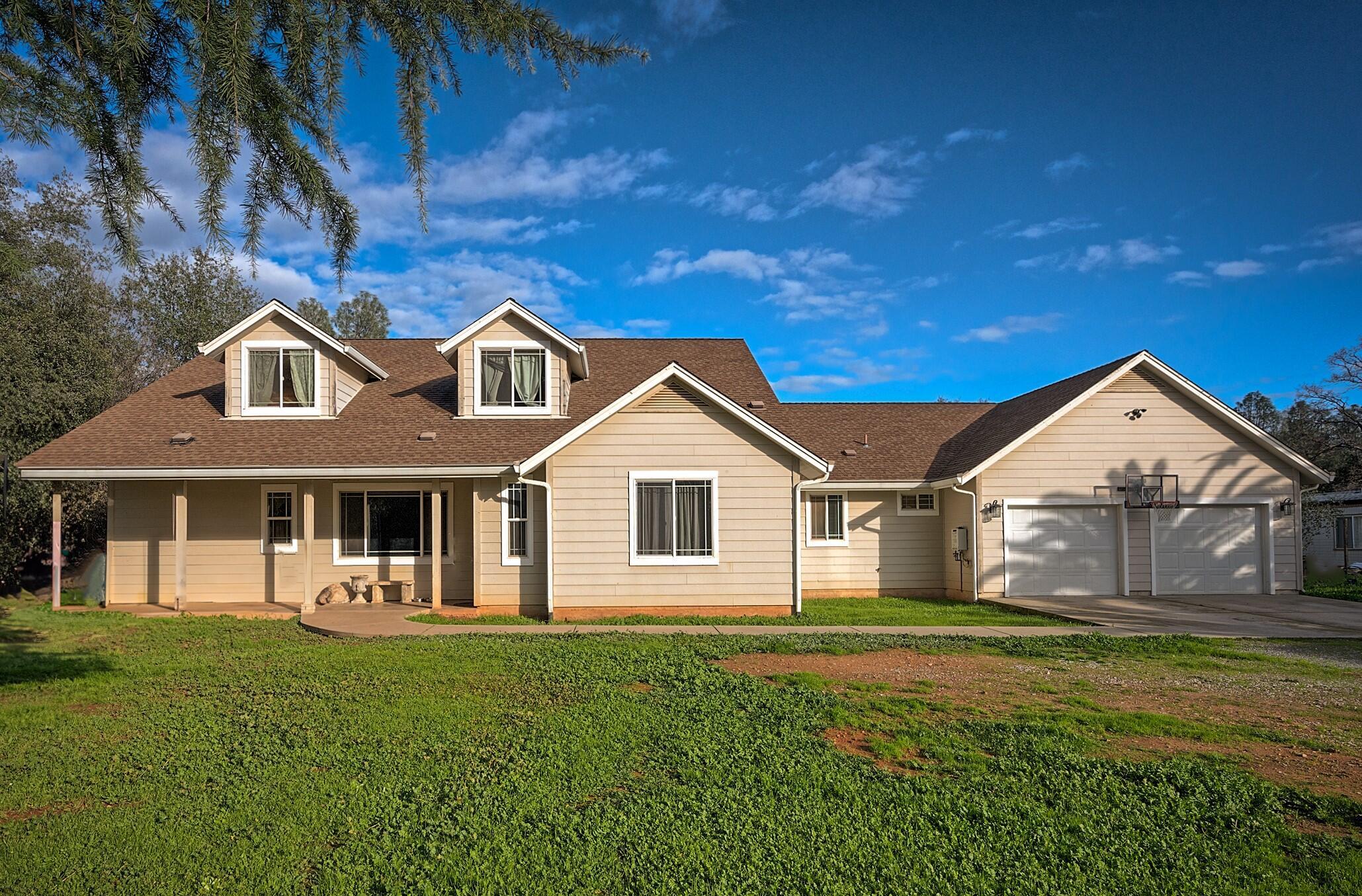 a front view of a house with a garden