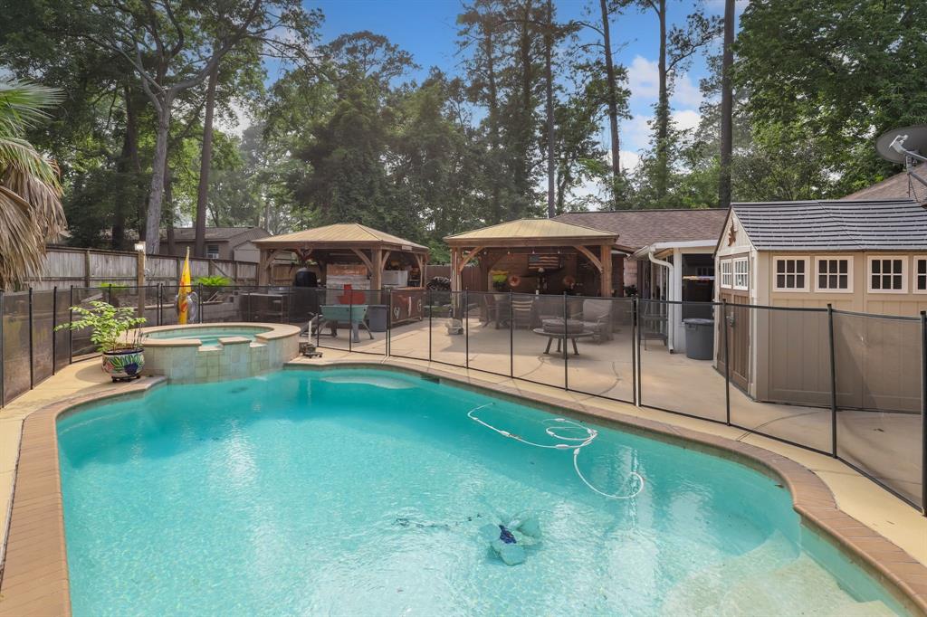 a swimming pool with outdoor seating and yard