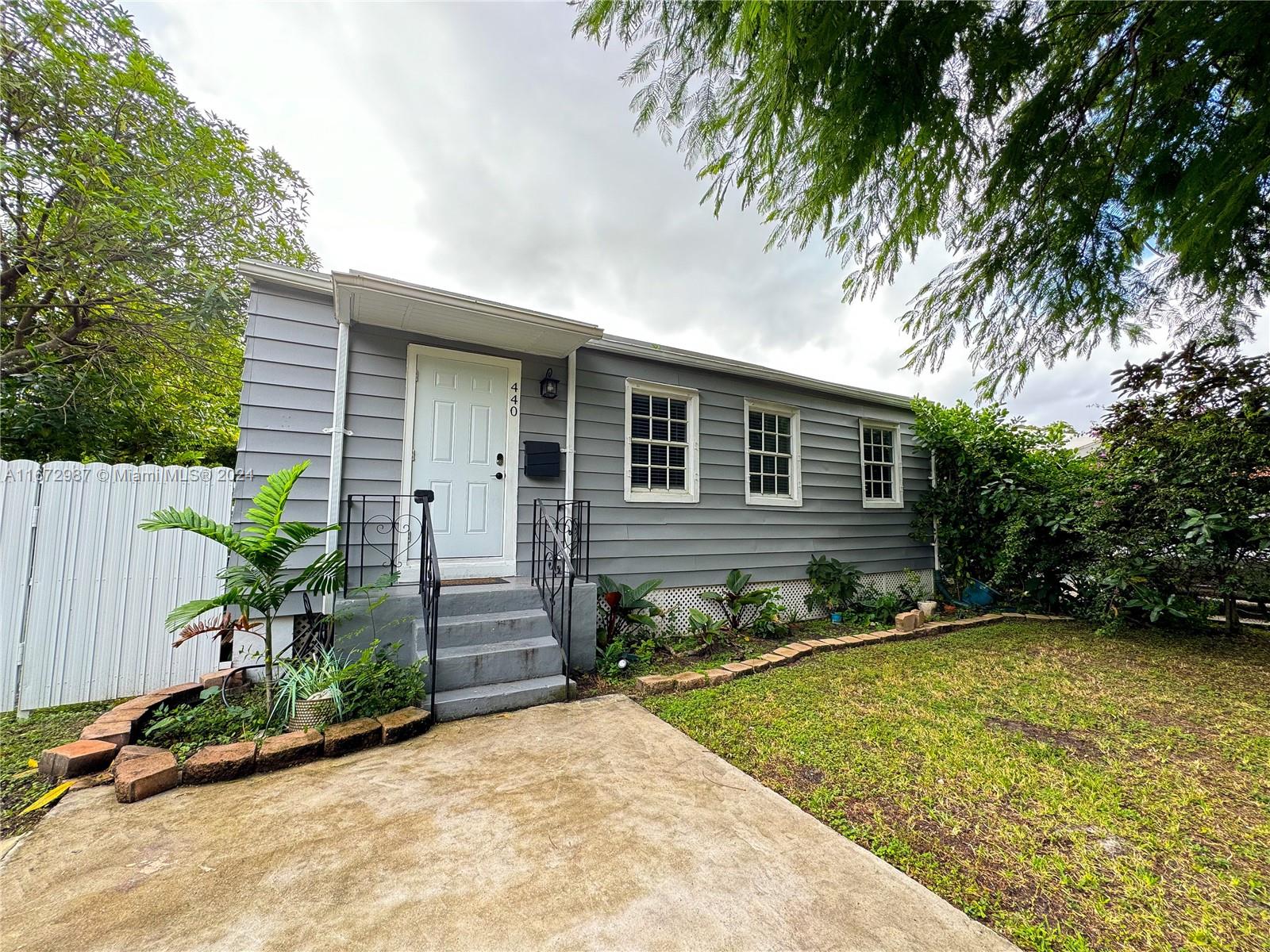 a front view of a house with garden