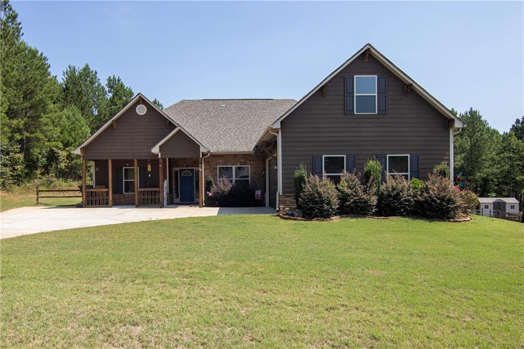 a front view of a house with a yard and garage