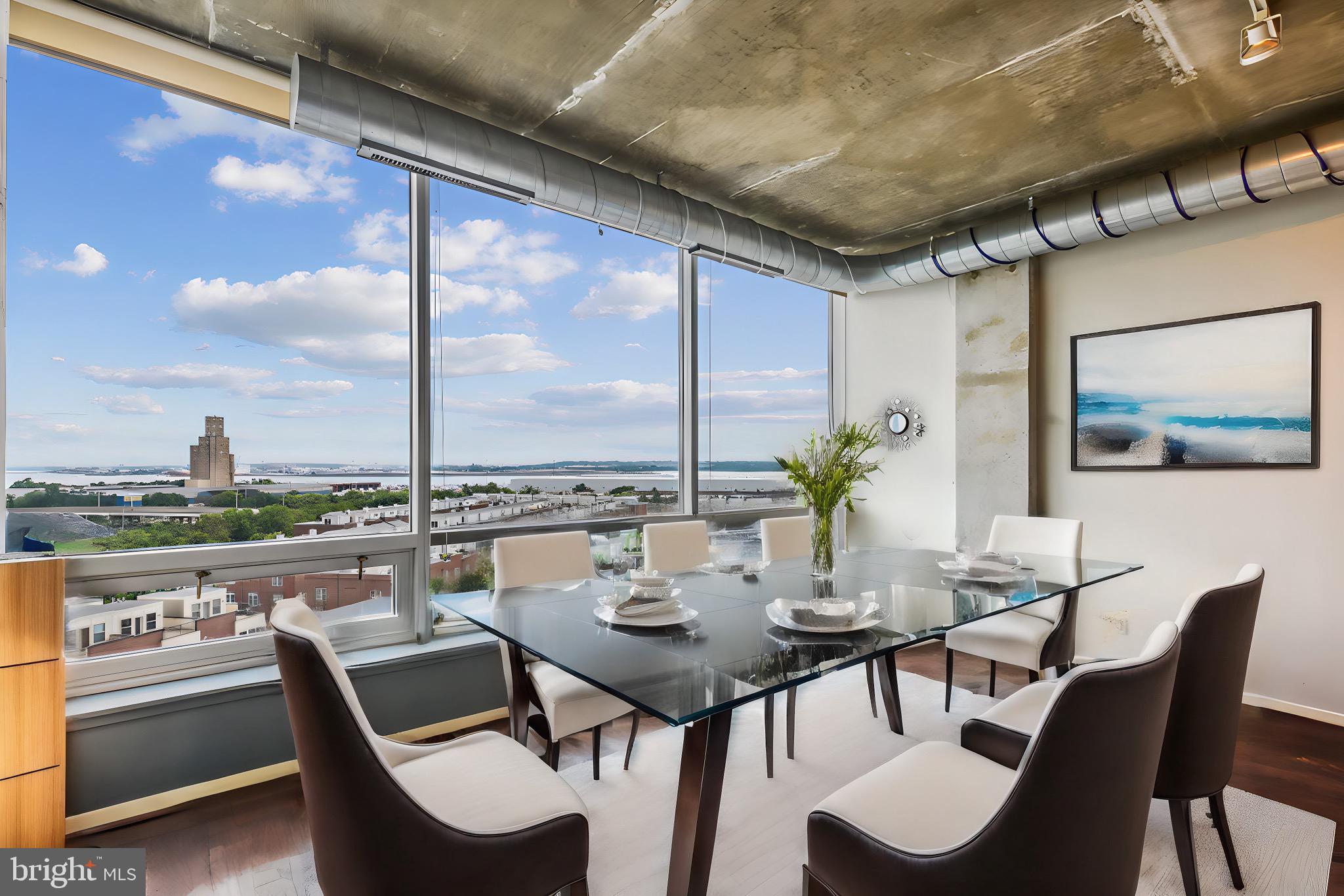 a view of a dining room with furniture large windows and wooden floor