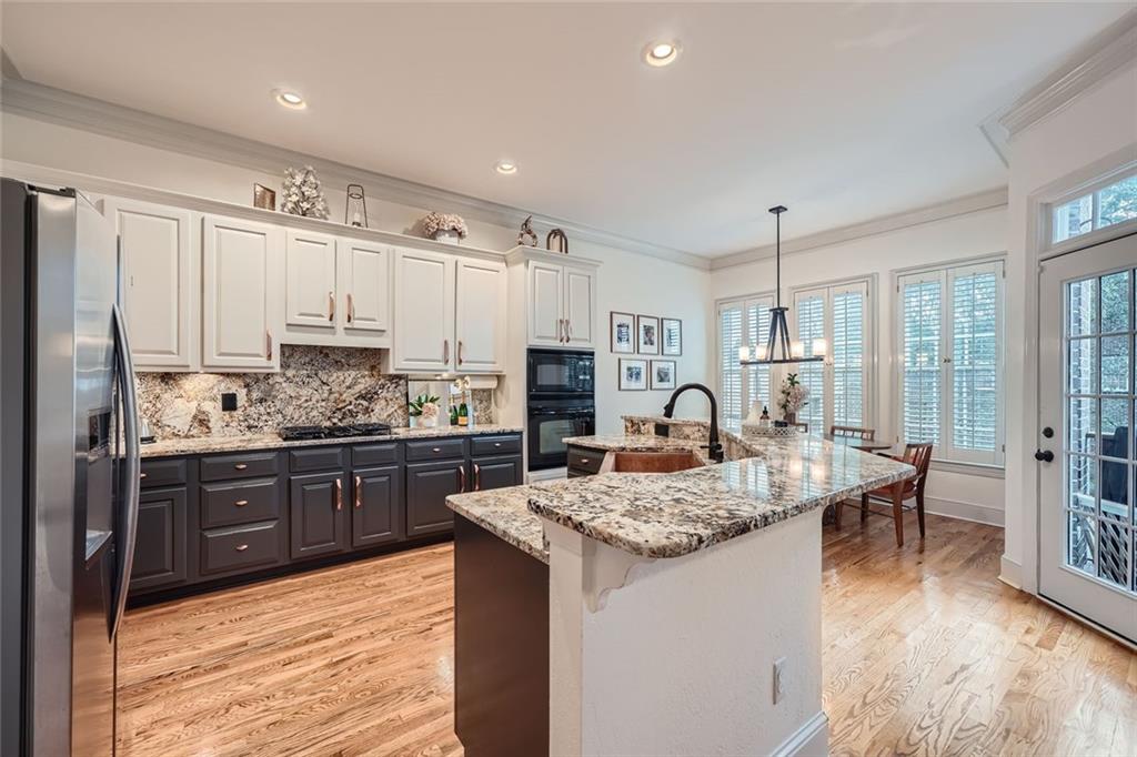 a kitchen with sink refrigerator and cabinets