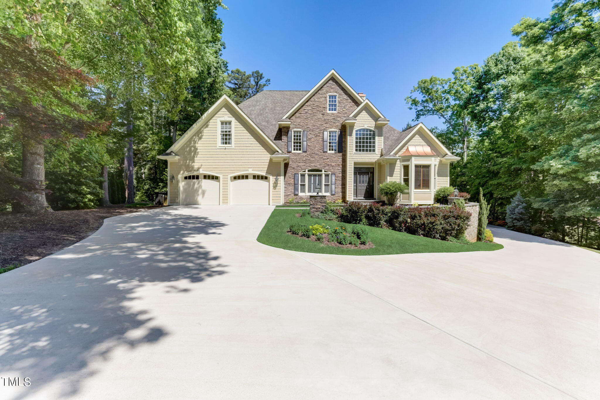 a view of a house with a yard and large trees