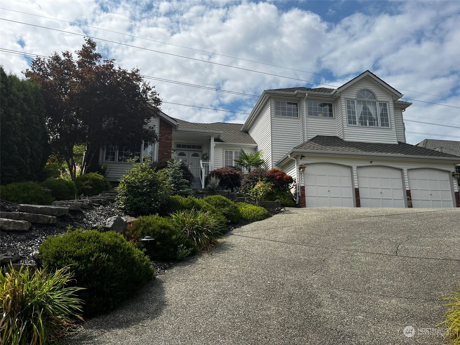 a front view of a house with a yard and garage