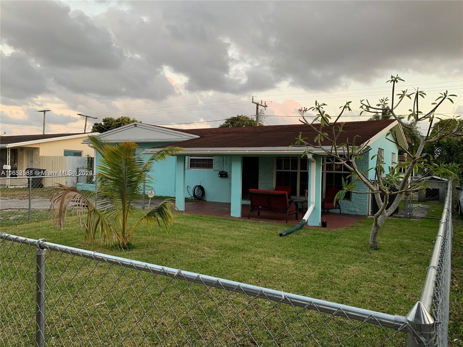 a view of a house with a backyard porch and sitting area