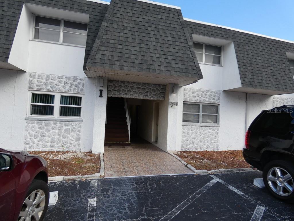 a front view of a house with parking space