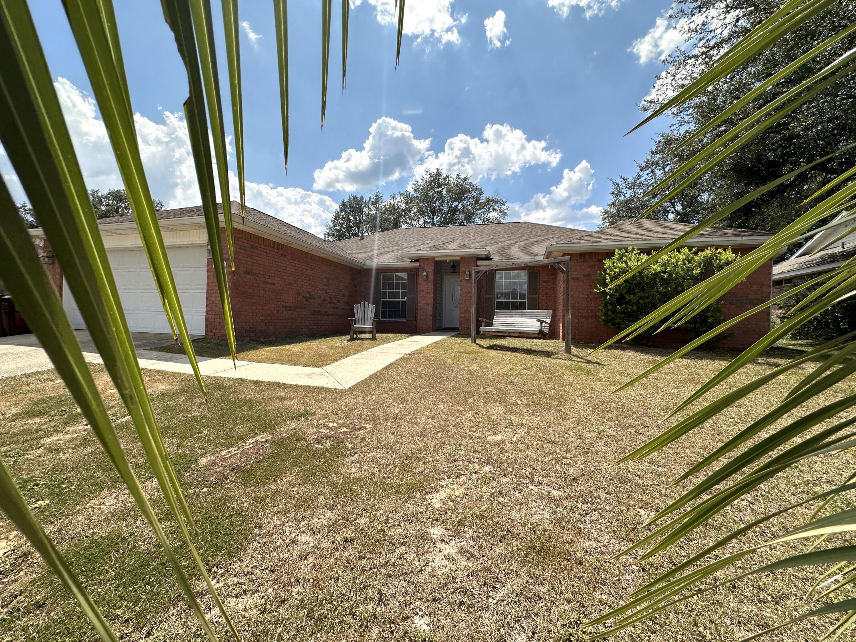 a view of a house with backyard and balcony