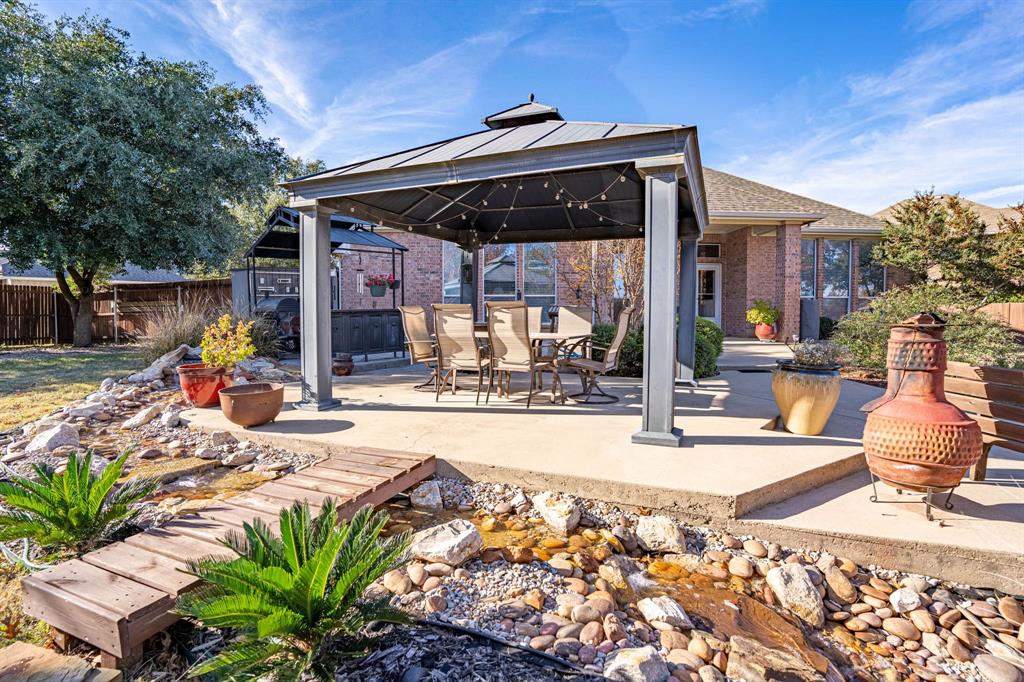 a view of a backyard patio and swimming pool