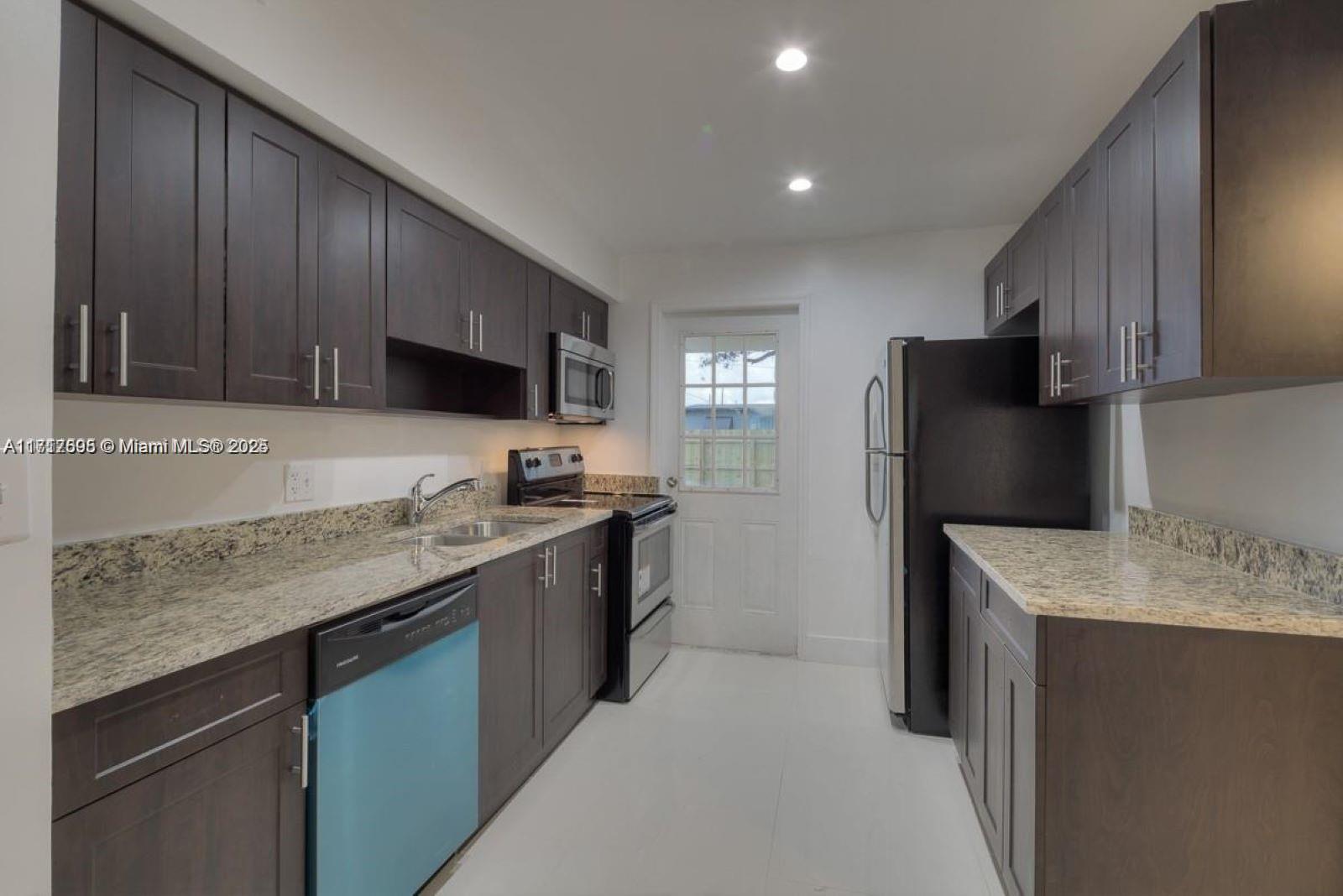 a kitchen with a sink stove and refrigerator