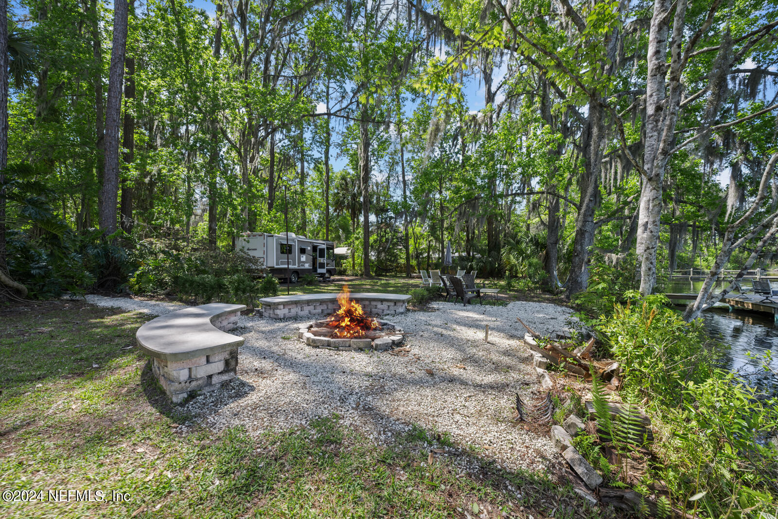 a view of a backyard with table and chairs and plants