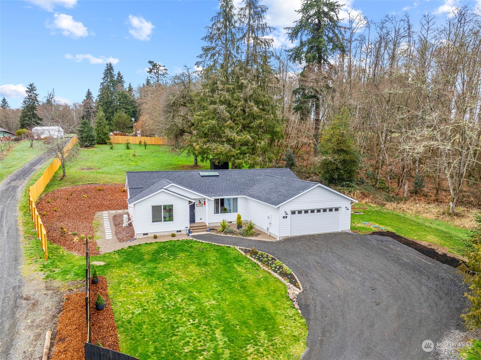 an aerial view of a house with a garden and trees