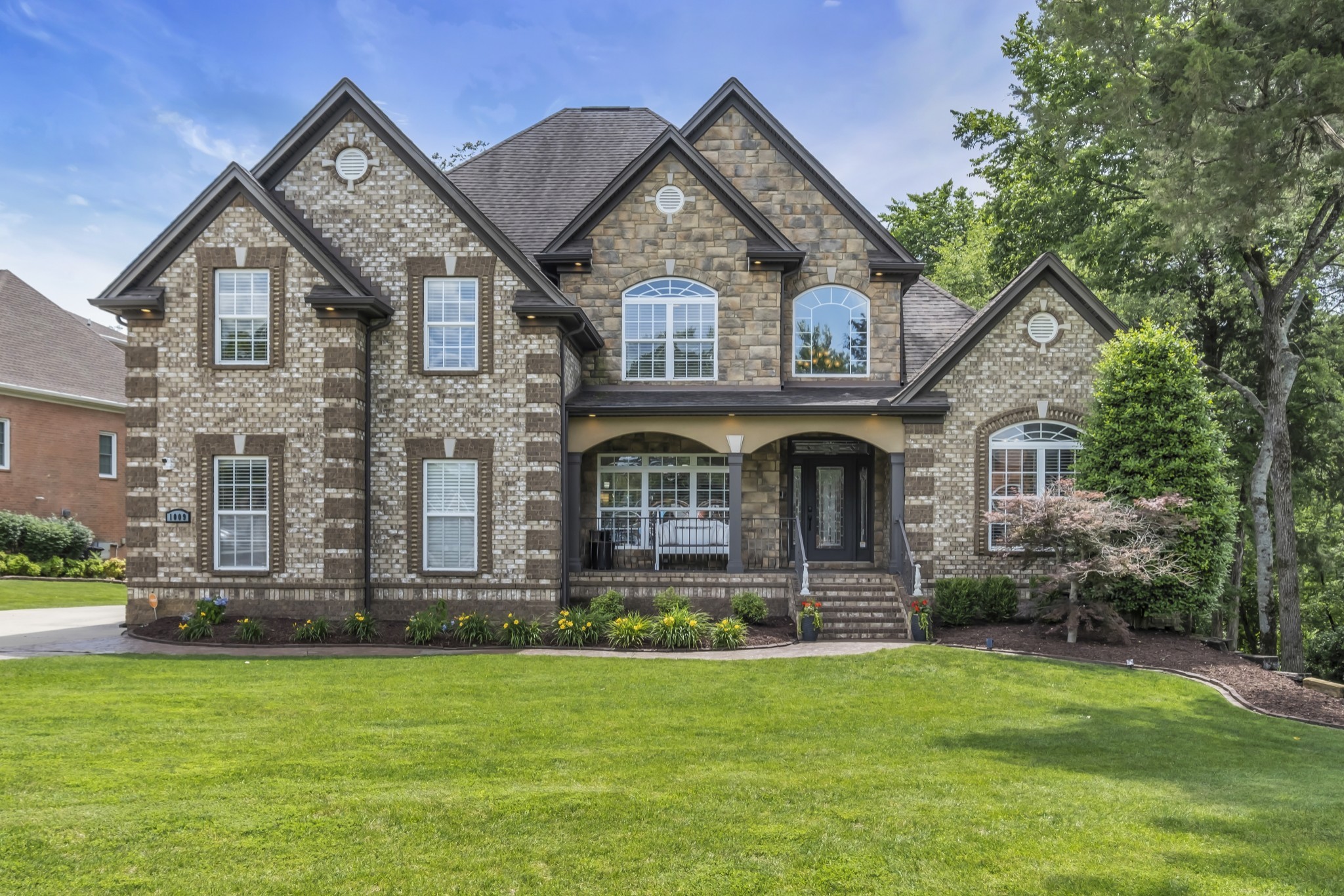 a front view of a house with garden