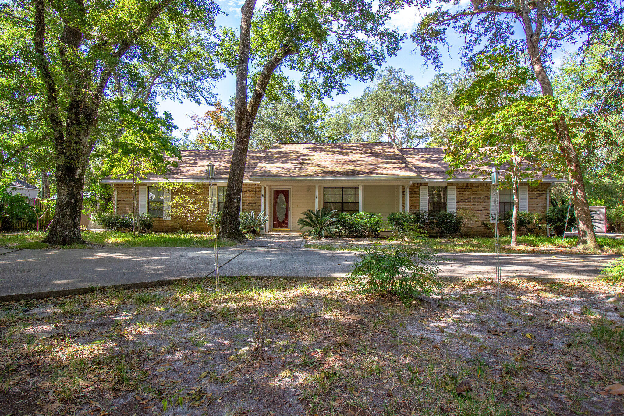 a view of a house with yard and tree s