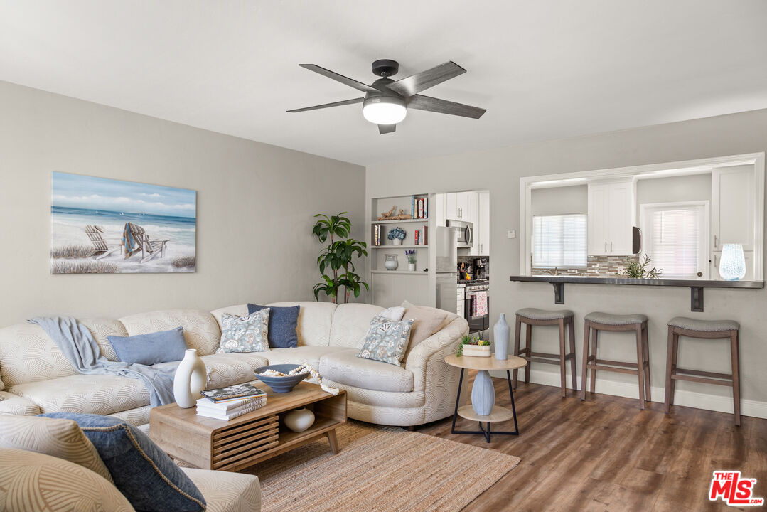 a living room with furniture and a wooden floor