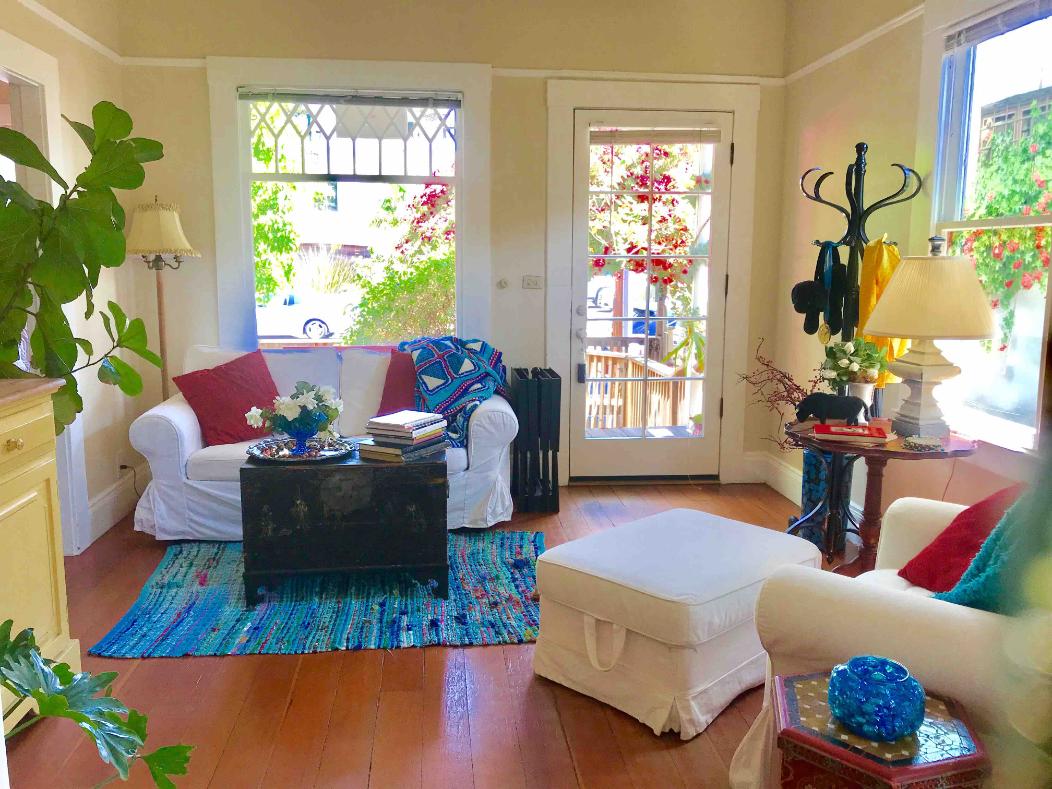 a living room with furniture and a potted plant