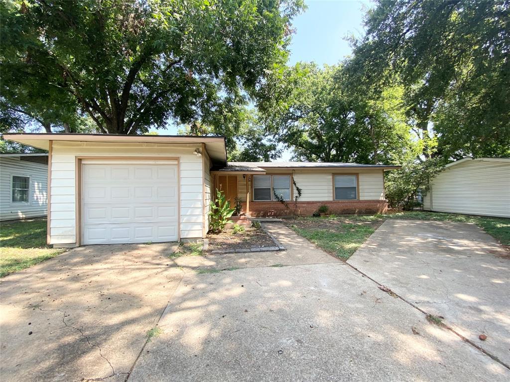 a view of a house with a yard and garage