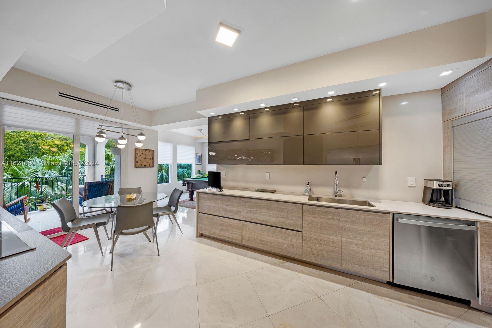 a large white kitchen with a large window