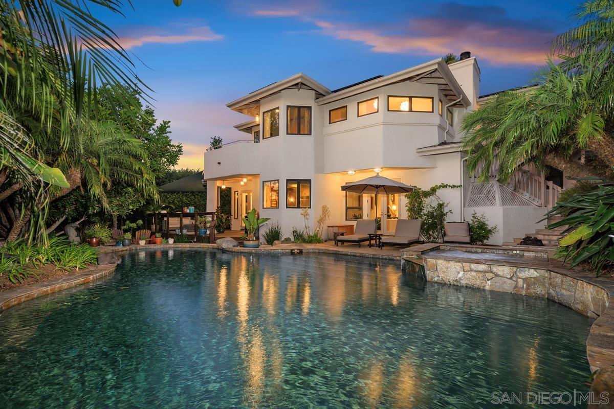 a front view of a house with swimming pool having outdoor seating