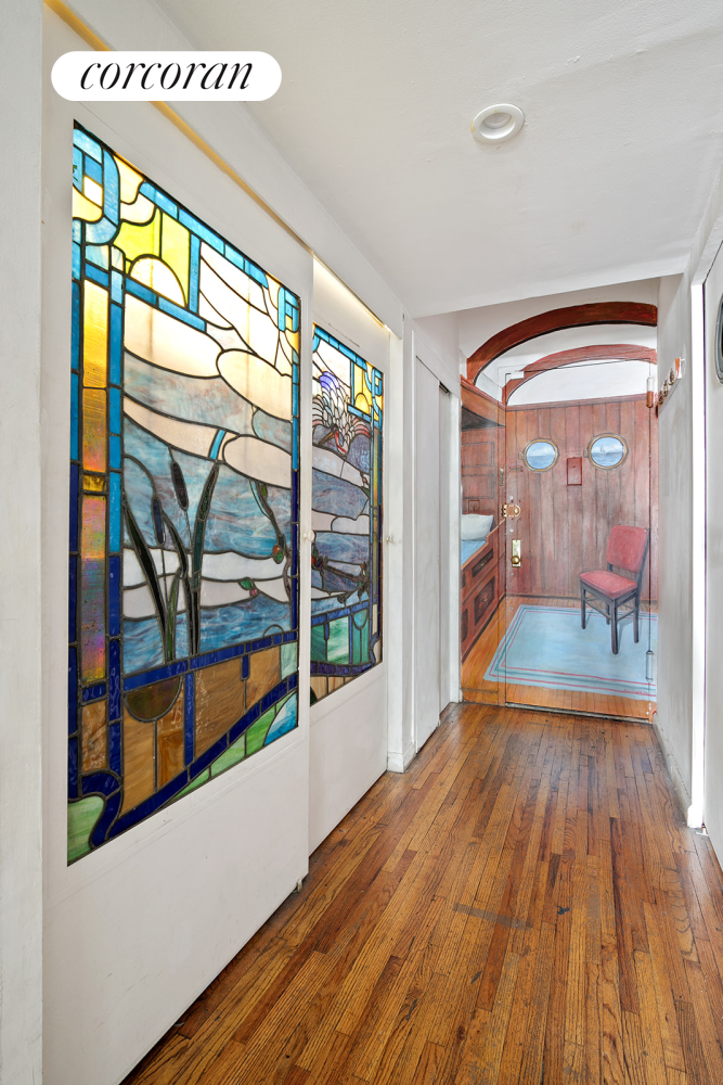 a view of an entryway with wooden floor