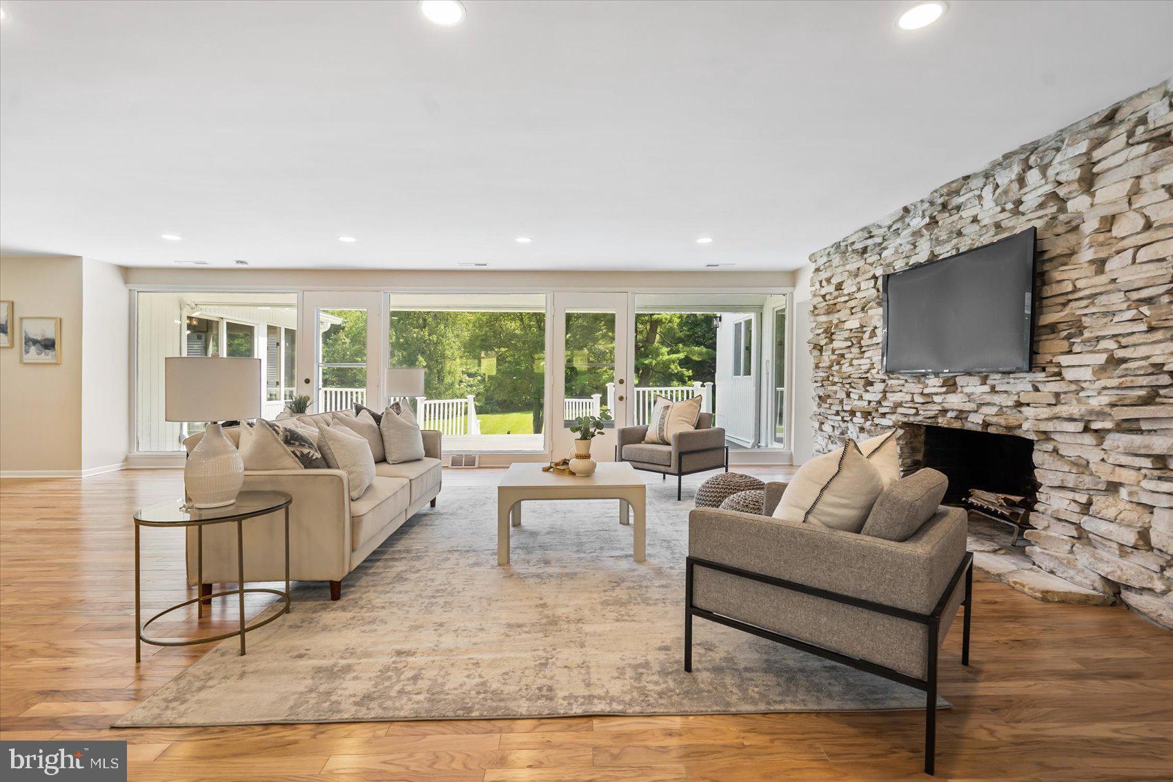 a living room with fireplace furniture and a flat screen tv