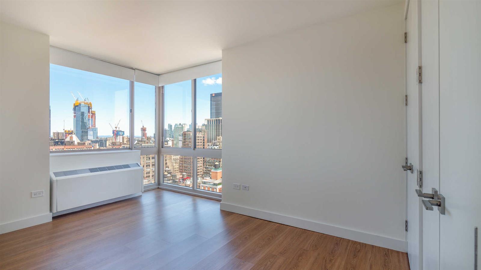 a room with a wooden floor and a window