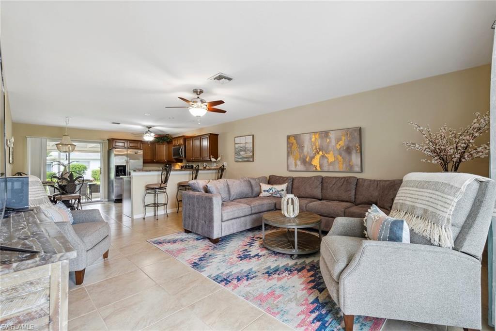 Tiled living room featuring ceiling fan