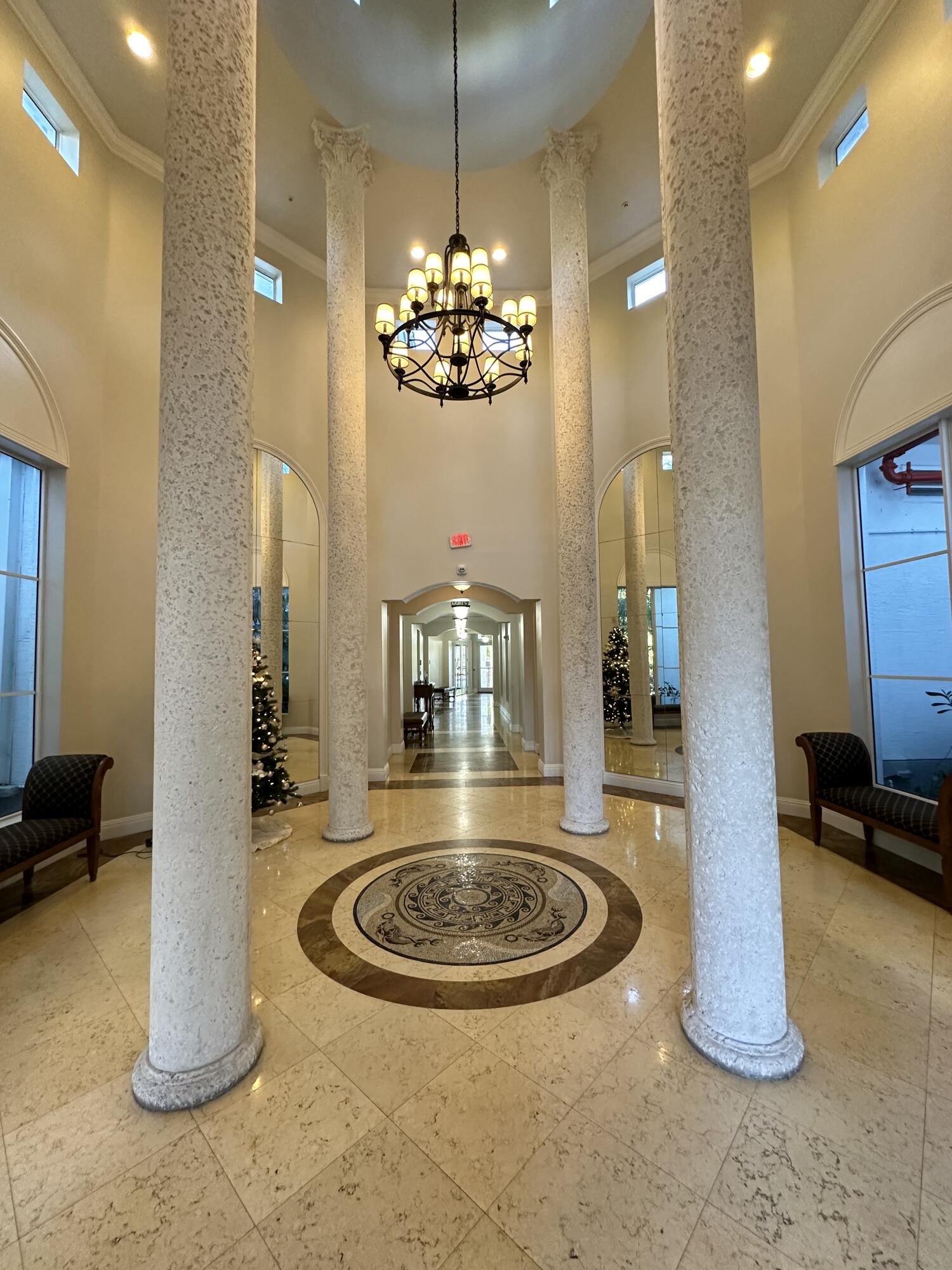 a view of a room with a chandelier furniture and windows