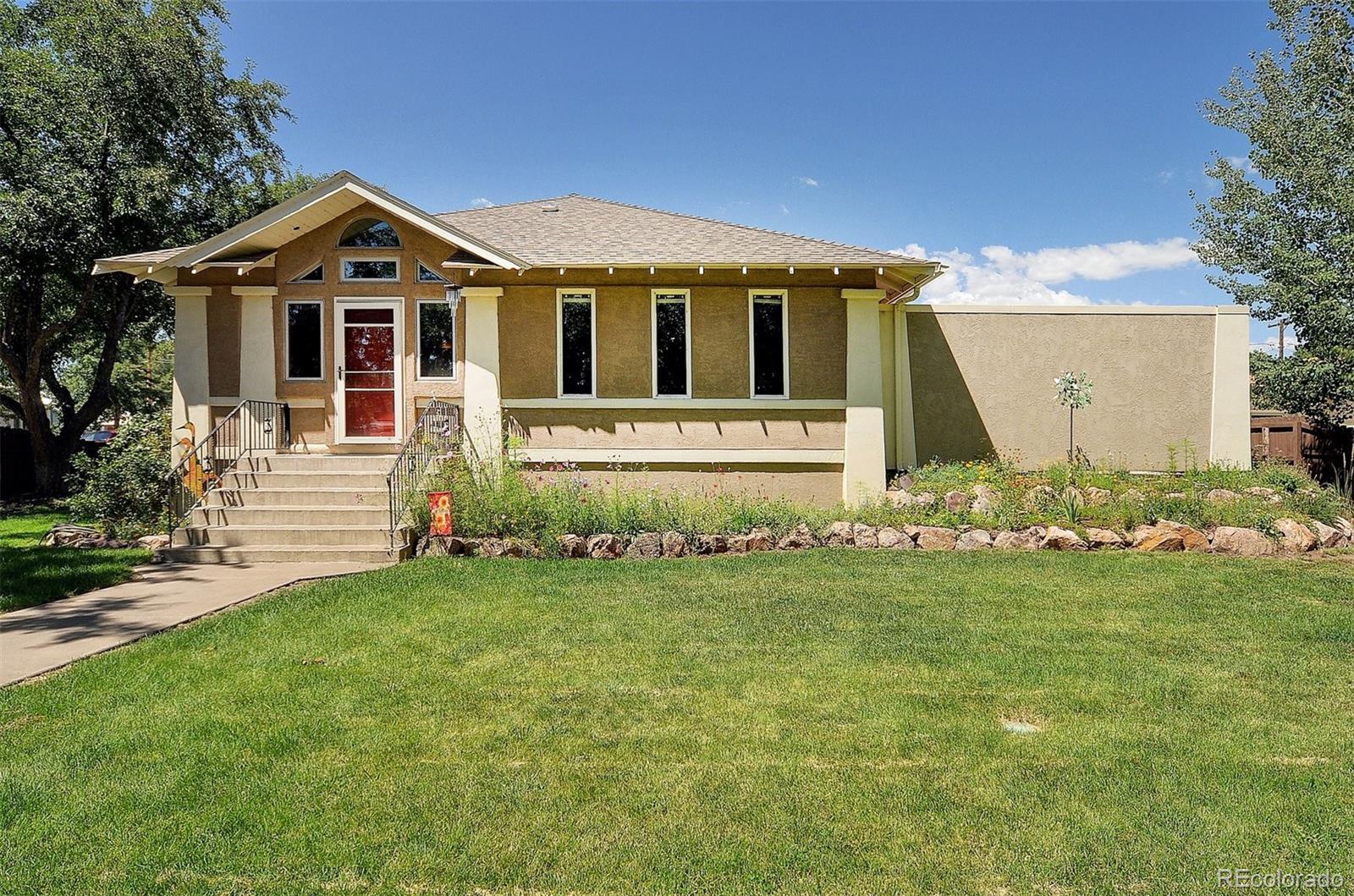 a front view of a house with a garden