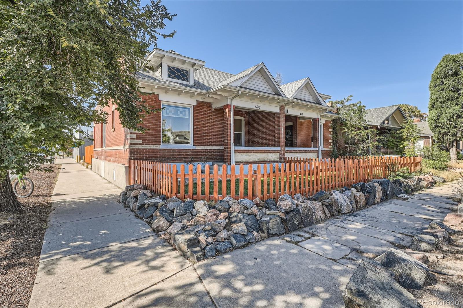 a front view of a house with a fence