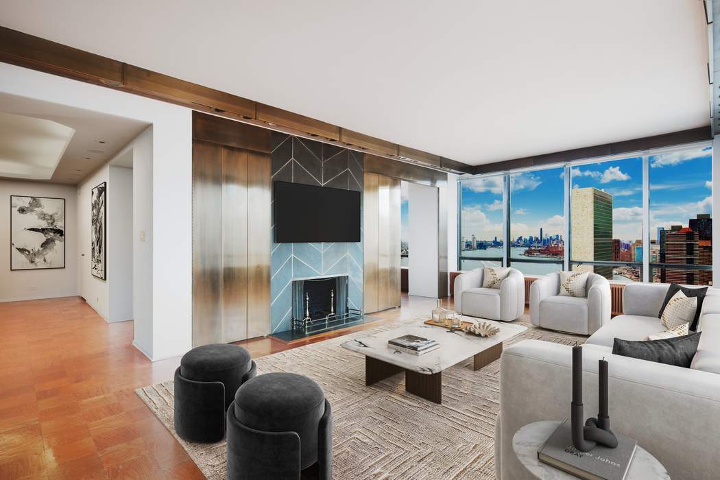 a living room with furniture fireplace and a large window