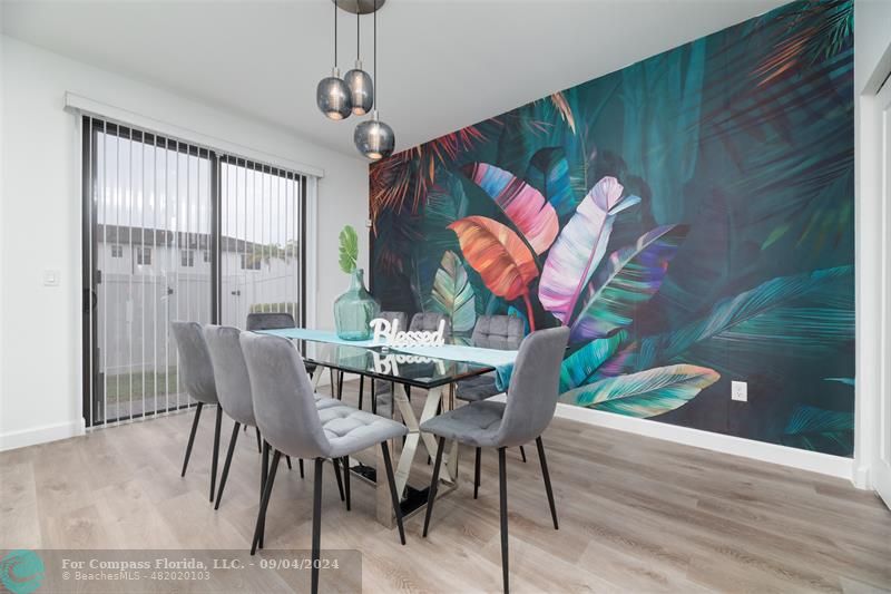 a view of a dining room with furniture wooden floor and chandelier