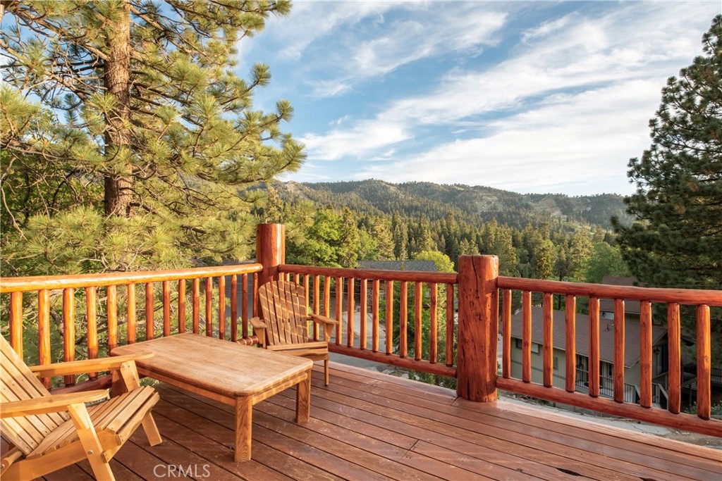 a view of a wooden chairs on the roof deck