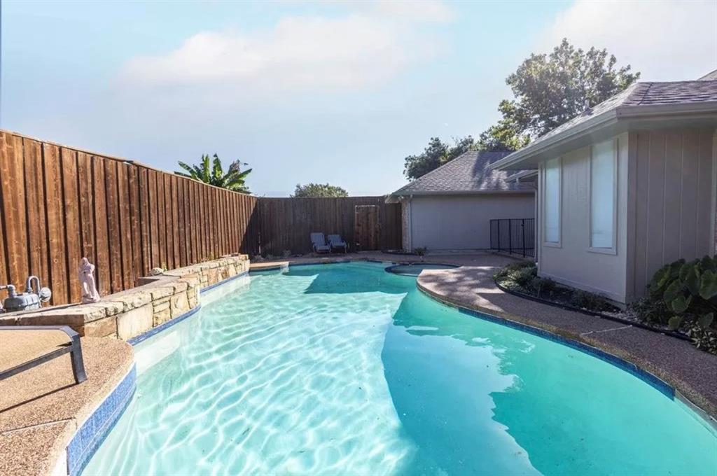 a view of a backyard with plants and a patio