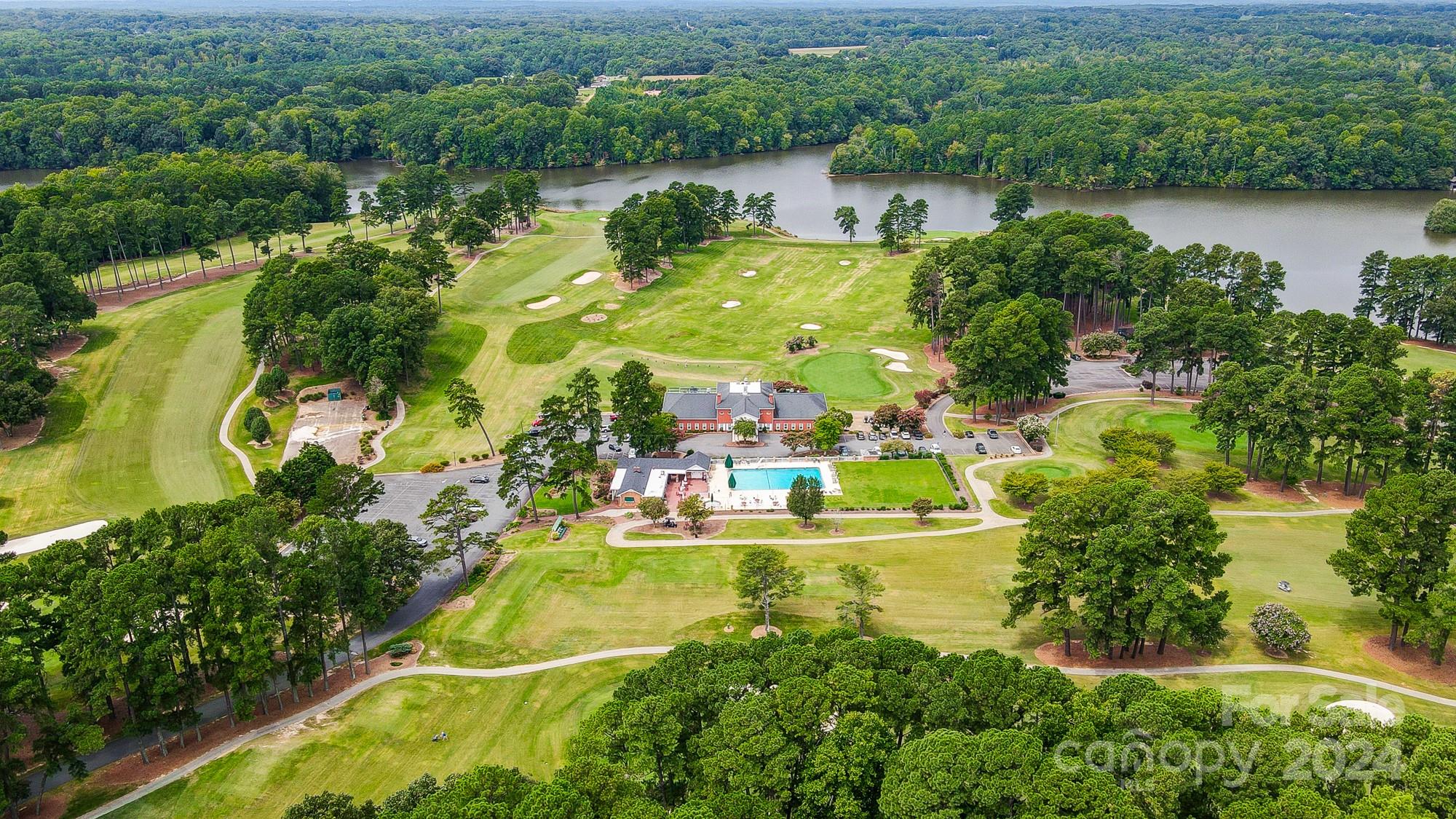 an aerial view of a house with a garden and lake view