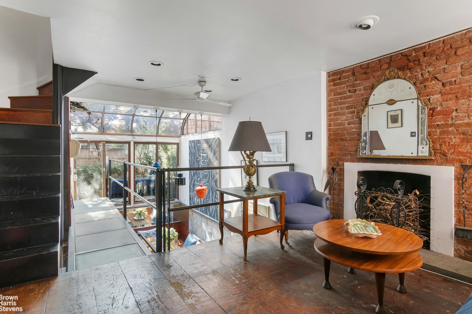 a living room with furniture a fireplace and a chandelier