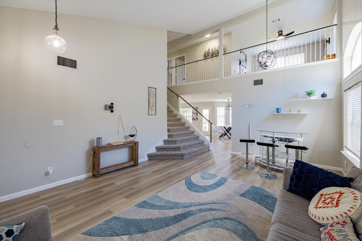 a living room with furniture and wooden floor